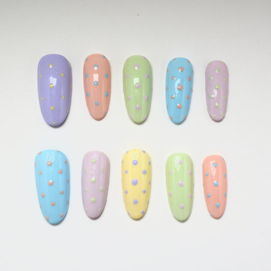 Pastel-colored nail art designs on a white background