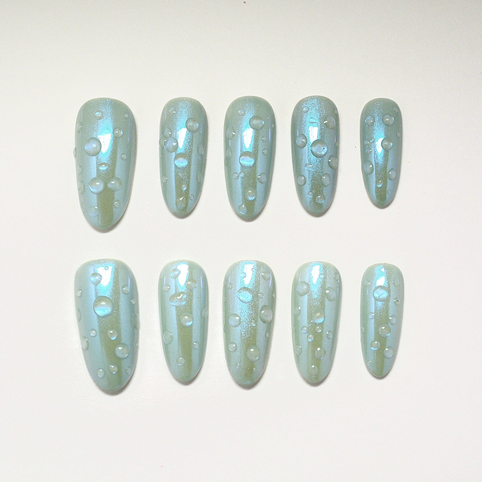 Set of light blue nail polish with glitter on a white background