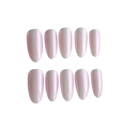 Set of pink nail extensions in a clear case on a light gray background
