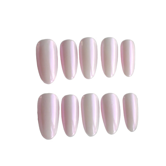 Set of pink nail extensions in a clear case on a light gray background